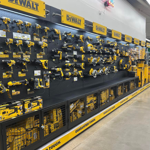 Display of DEWALT hand and power tools including circular saws, reciprocating saws, drills, and more, all neatly organized on our DeWALT shelves in our store.