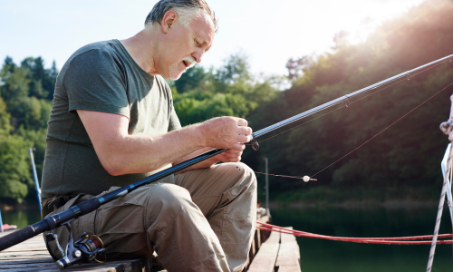 Man putting bait on fishing line